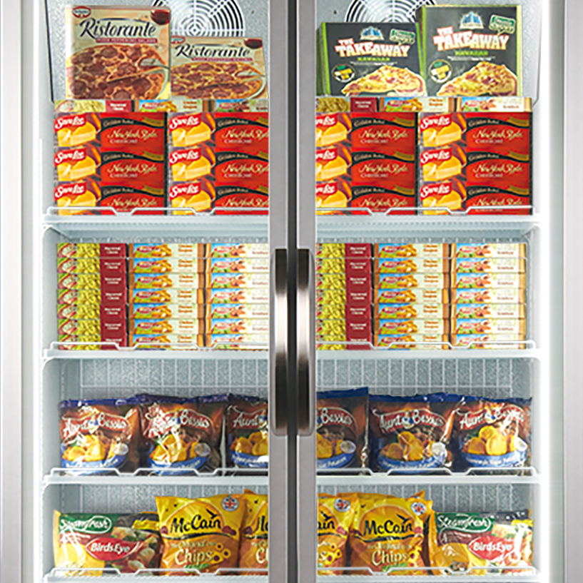 Frozen food items are displayed inside a commercial refrigerator with two glass doors; several shelves are stocked with pizzas, potato chips, and other packaged goods. Brands visible include "Ristorante," "McCain," "Aunt Bessie's," and "Birds Eye."
