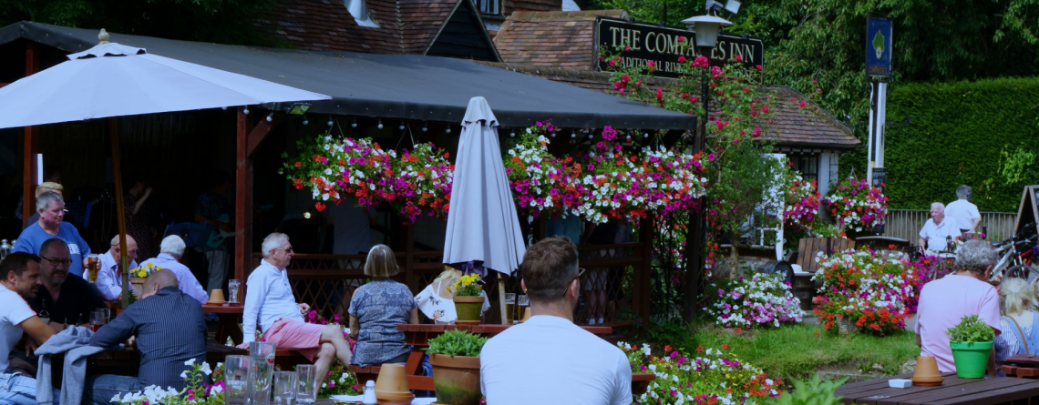 People enjoying drinks in a pub garden, ideal setting for a Husky outdoor back bar fridge in hospitality venues