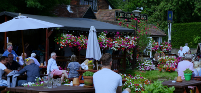 People enjoying drinks in a pub garden, ideal setting for a Husky outdoor back bar fridge in hospitality venues