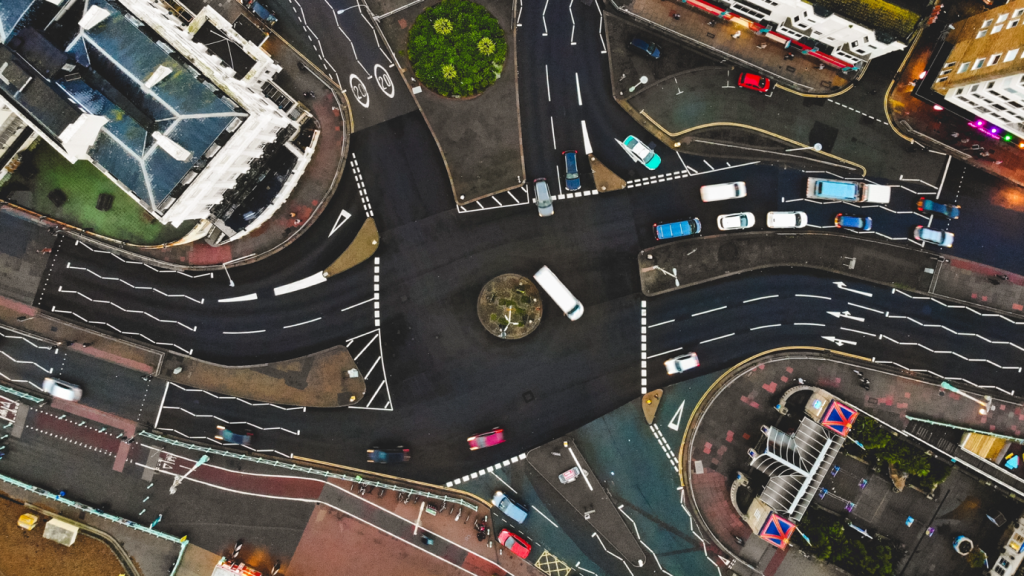 Aerial view of busy UK city traffic showing the challenges of last-mile logistics and how smart fridges for last-mile delivery can reduce van trips and congestion.