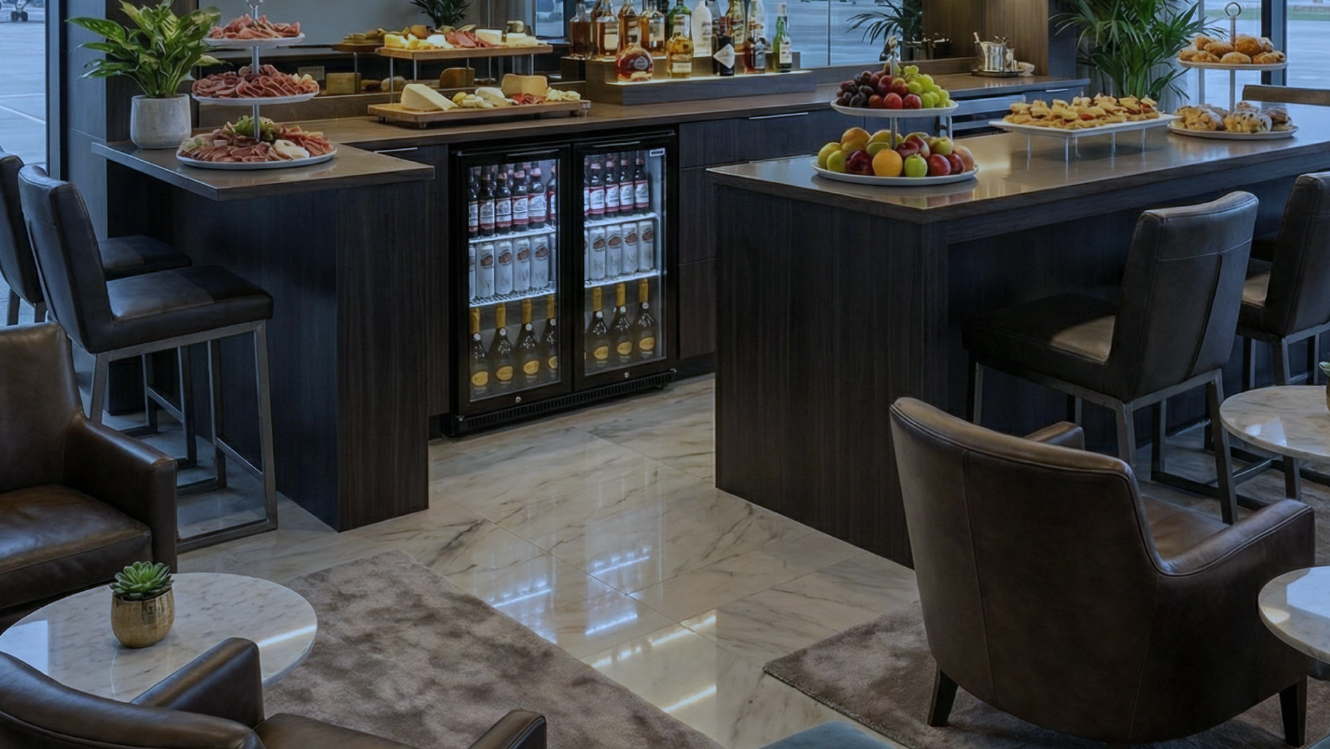 Drinks fridge built into a modern bar island, fully stocked with beverages and illuminated for premium display in a hospitality setting