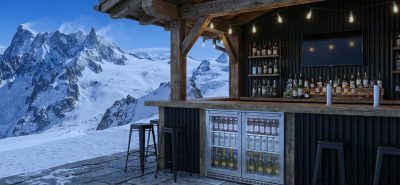 High quality refrigeration drinks fridge installed in an outdoor mountain bar, showcasing chilled beverages in a premium hospitality setting